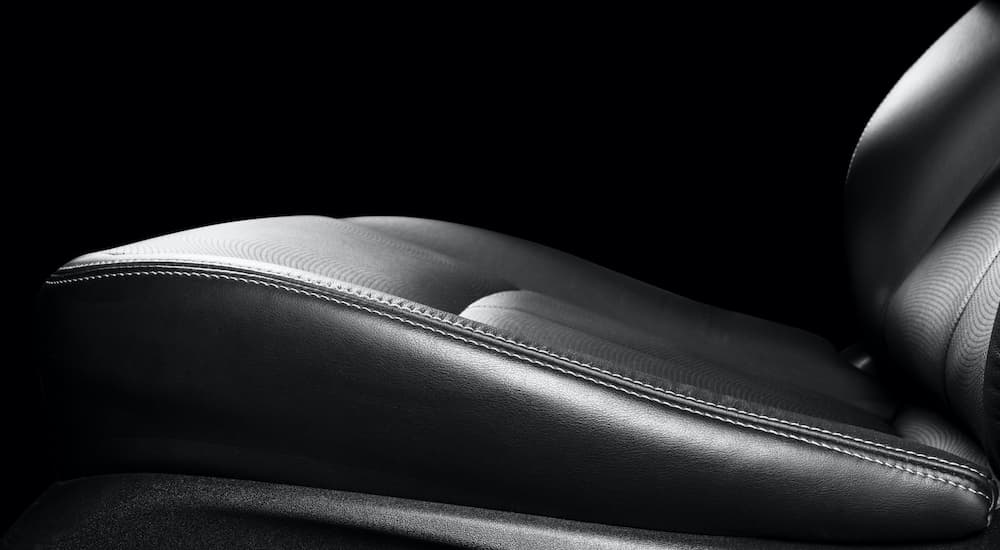 A leather car seat is shown in close up.