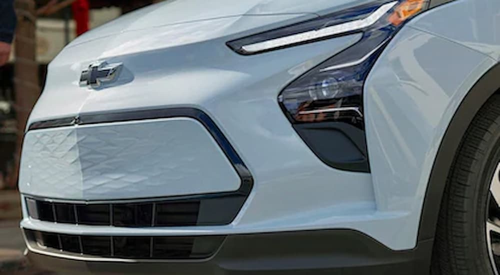 A close up of the front of a light gray 2022 Chevy Bolt EV is shown.