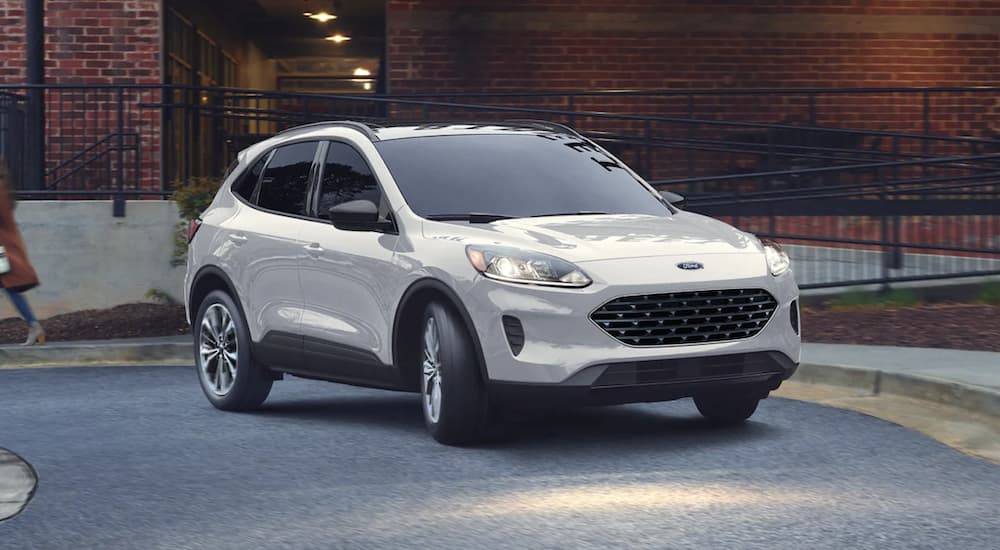 A white 2022 Ford Escape is shown from the front parked in front of a building.