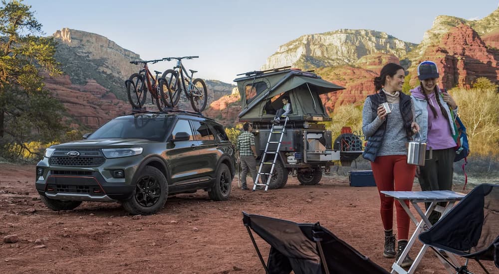A dark green 2022 Ford Explorer Timerline is shown at a campsite.