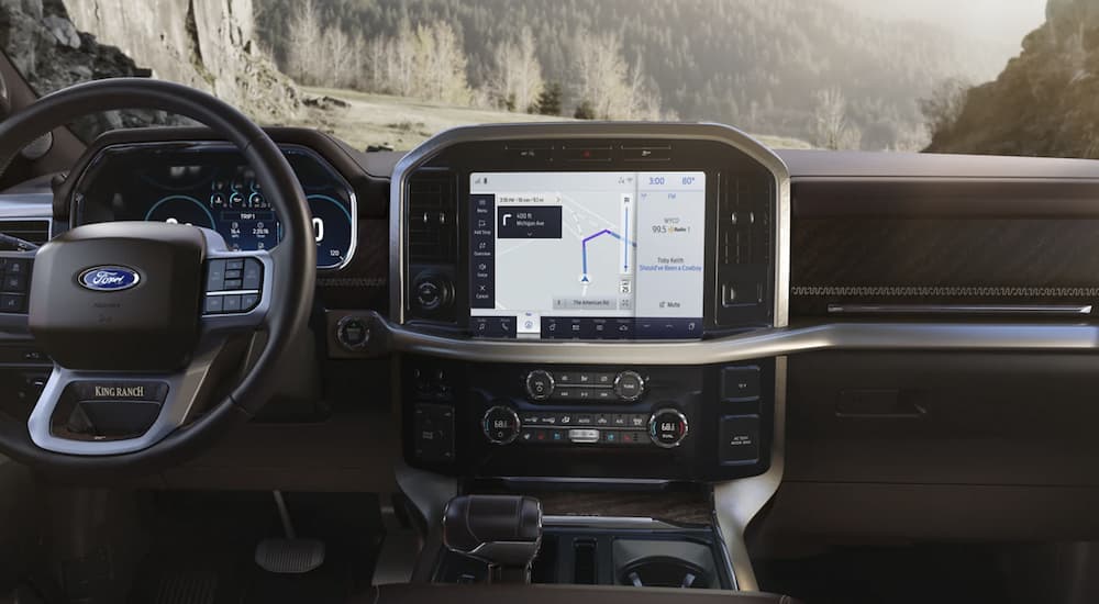 The black interior of a 2022 Ford F-150 shows the infotainment screen.