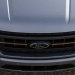 The silver hood of a 2022 Ford F-150 is shown parked during a 2022 Ford F-150 vs 2022 Chevy Silverado 1500 comparison.