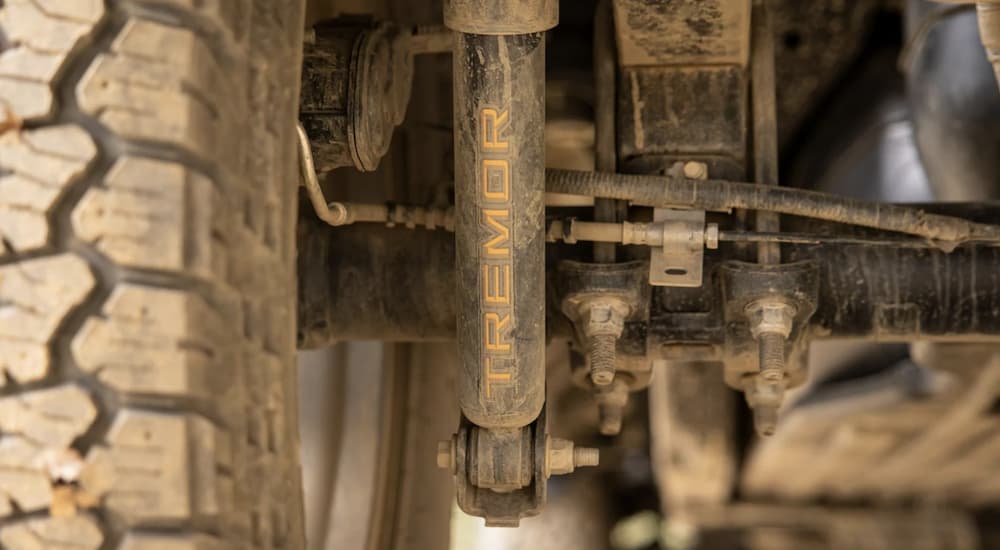 The shocks of a 2022 Ford F-150 shows the Tremor logo in close up.