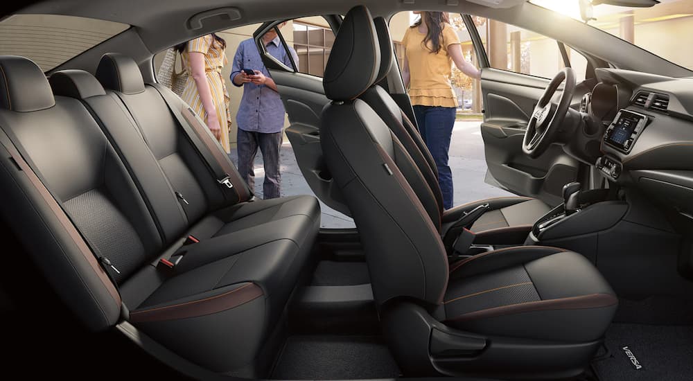 The black interior of a 2022 Nissan Versa shows two rows of seating.