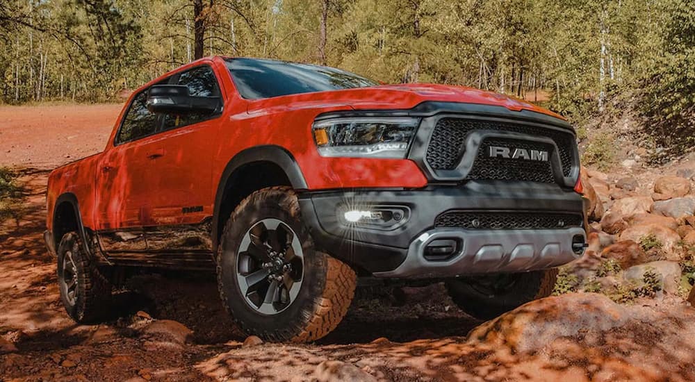A red 2022 Ram 1500 is shown from the front parked in the mountains after winning a 2022 Ram 1500 vs 2022 Chevy Silverado 1500 comparison.