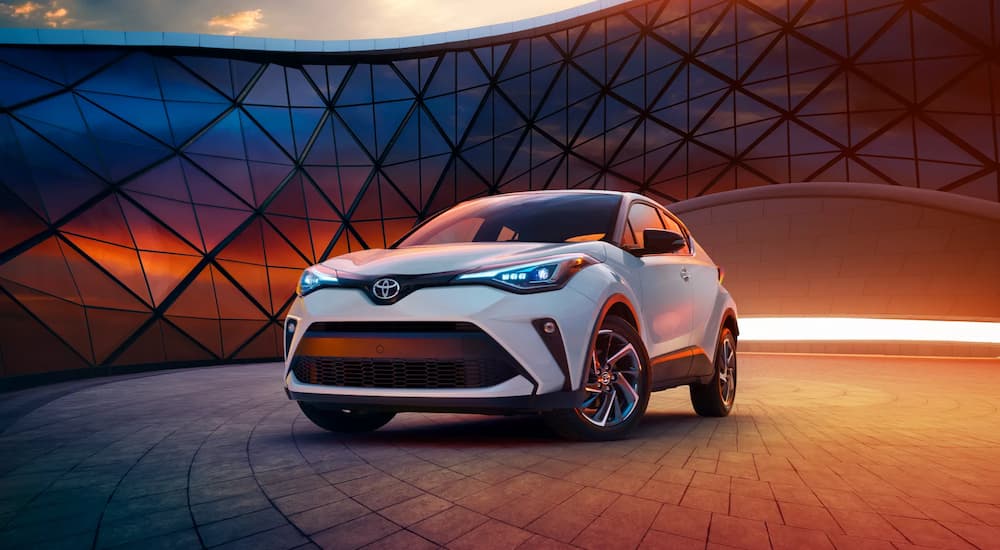 A white 2022 Toyota C-HR is shown parked in a modern gallery.