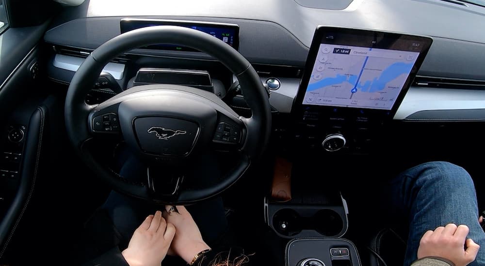 The black interior of a 2022 Ford Mustang Mach-E shows BlueCruise in action.