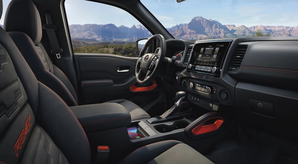 The interior of a 2022 Nissan Frontier Pro-4x is shown from the passenger seat.