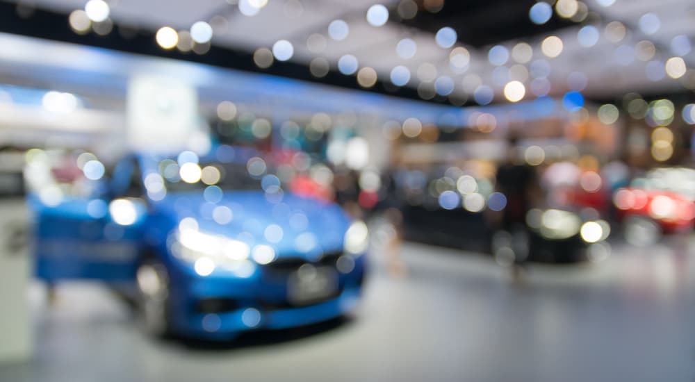 An auto show is shown through a blurry filter.