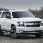 A white 2022 Chevy Tahoe is shown from the front parked in of a forest.