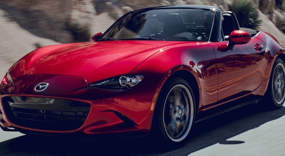 A popular used car, a red 2019 Mazda Miata MX-5, is shown from the front.