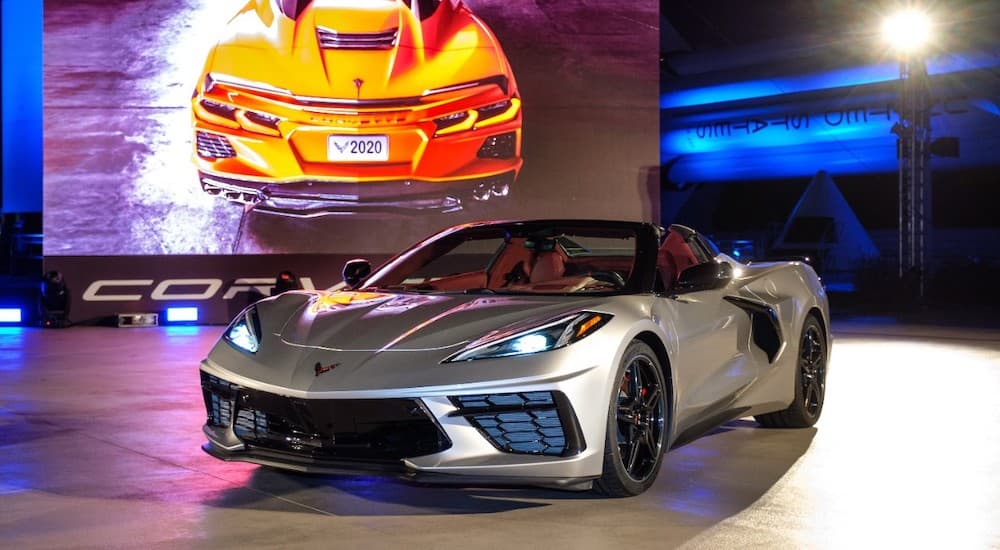 A sliver 2022 Chevy Corvette is shown from a front angle on a stage after leaving a Scottsboro Chevy dealer.