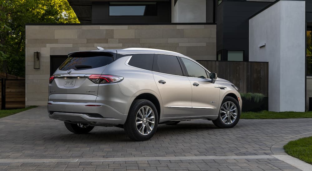 A silver 2022 Buick Enclave Avenir is shown from behind at an angle.