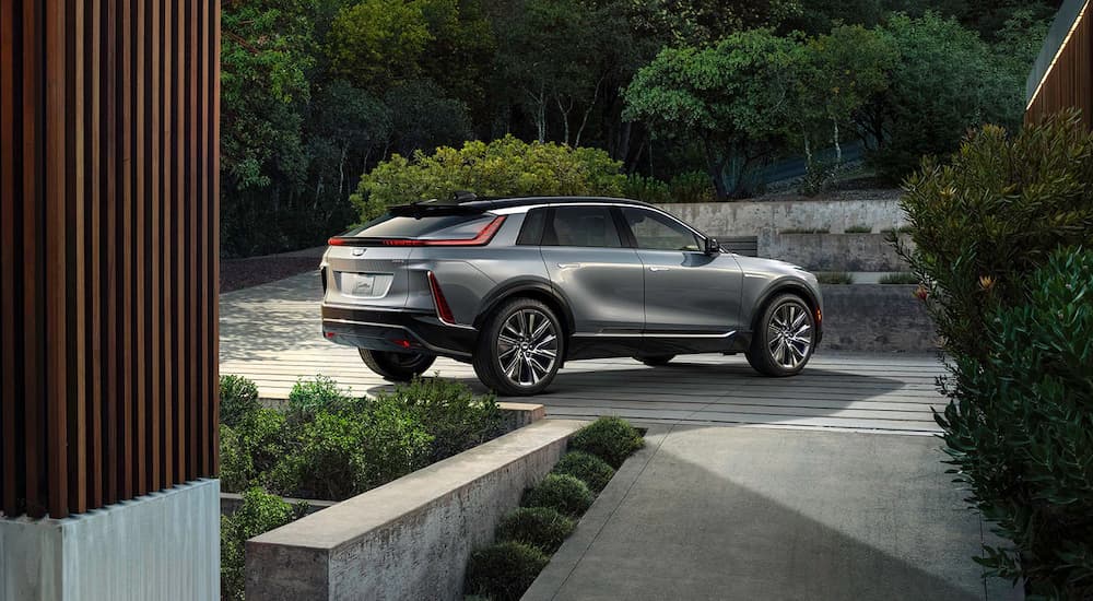 A grey 2023 Cadillac Lyriq is shown from the rear parked on a driveway.