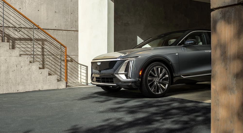 A grey 2024 Cadillac Lyriq leaving a parking garage after visiting a Cadillac dealer.