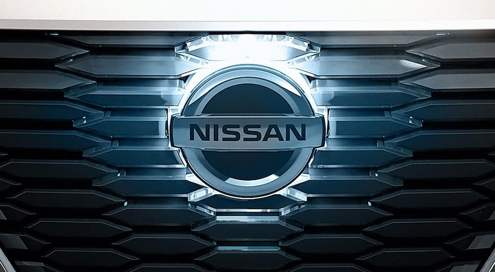 A close up shows the Nissan emblem on the grille of a Nissan Vmotion 2.0.