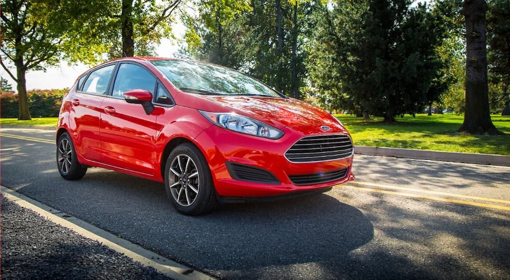 A red 2015 Ford Fiesta is shown from the front at an angle after leaving a used Ford dealership.