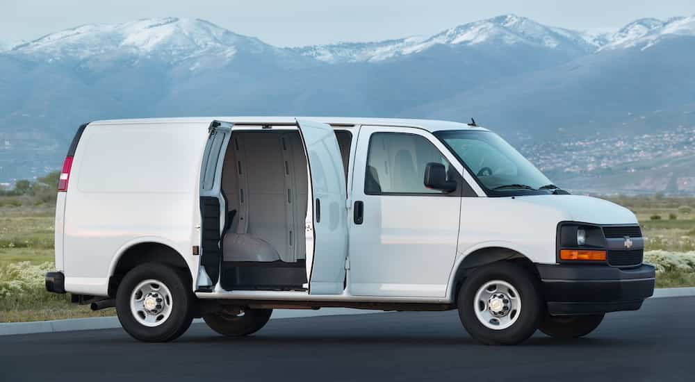 A white 2022 Chevy Express 2500 Van is shown from the side with the doors open after the owner searched 'used commercial vehicle dealer'.