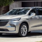 A silver 2022 Buick Enclave is shown parked in front of a modern house during a 2022 Buick Enclave vs 2022 Dodge Durango comparison.