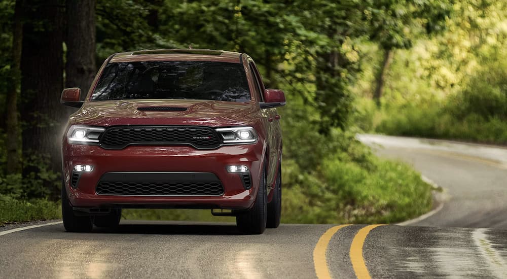 A red 2022 Dodge Durango is shown from the front driving on an open road.