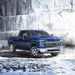 A blue 2022 Chevy Silverado 2500 HD is shown from the front at an angle while parked in a quarry.