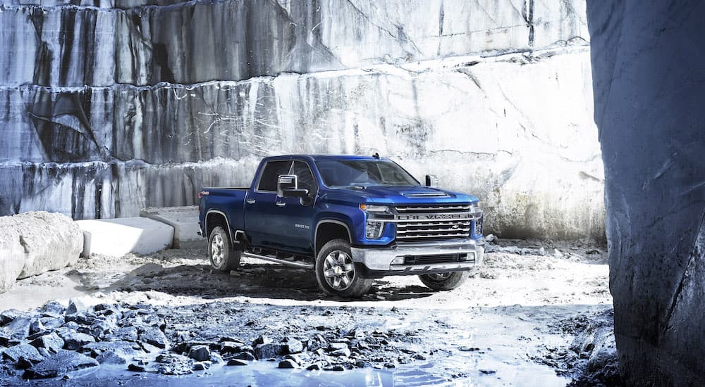 A blue 2022 Chevy Silverado 2500 HD is shown from the front at an angle while parked in a quarry.