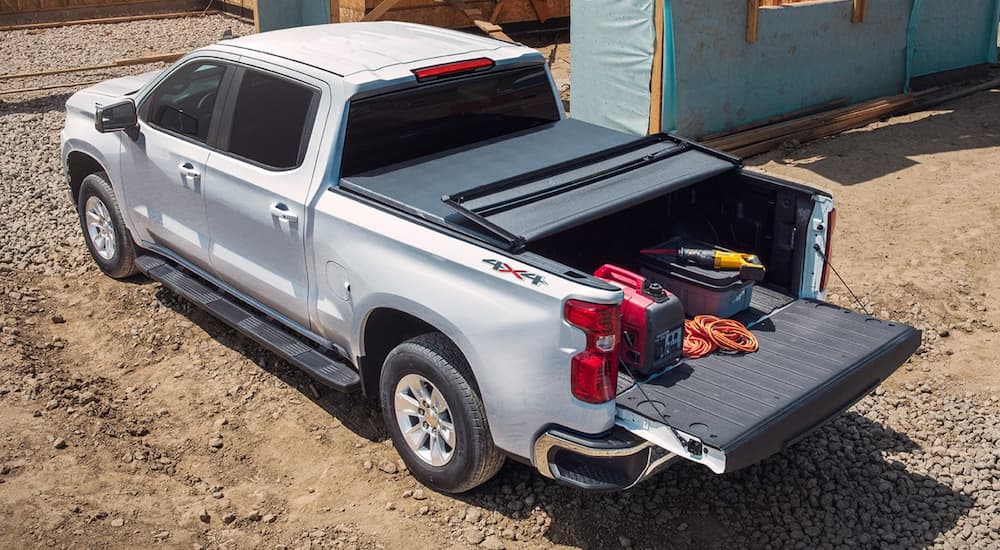 A white 2022 Chevy Silverado 1500 is shown from above parked at a construction site.