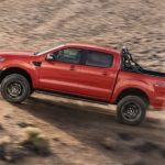 A red 2022 Ford Ranger is shown from the side off-roading in a desert.