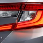 A close up shows the passenger side taillight and badging on a a grey 2022 Honda Accord Hybrid Touring after competing in a 2022 Honda Accord vs 2022 Toyota Camry competition.
