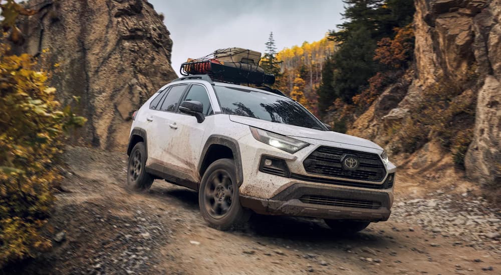 A white 2022 Toyota RAV4 TRD is shown from the front off-roading in the mountains.