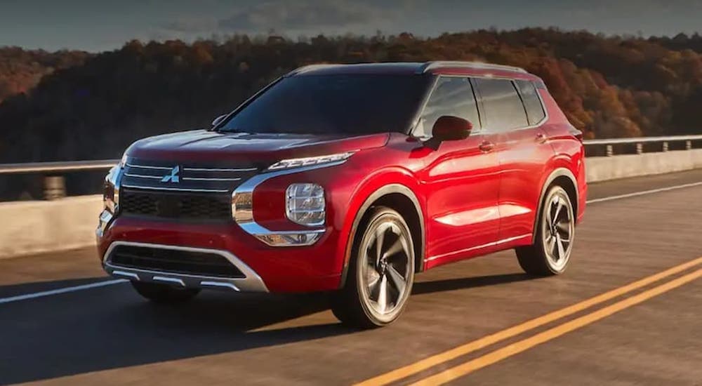 A red 2022 Mitsubishi Outlander is shown from the front at an angle.