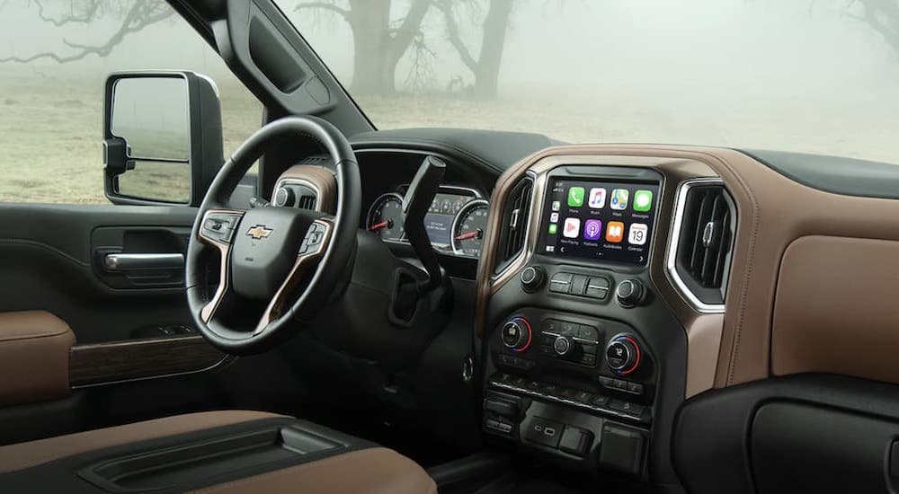 The black and brown interior shows the steering wheel and infotainment screen.