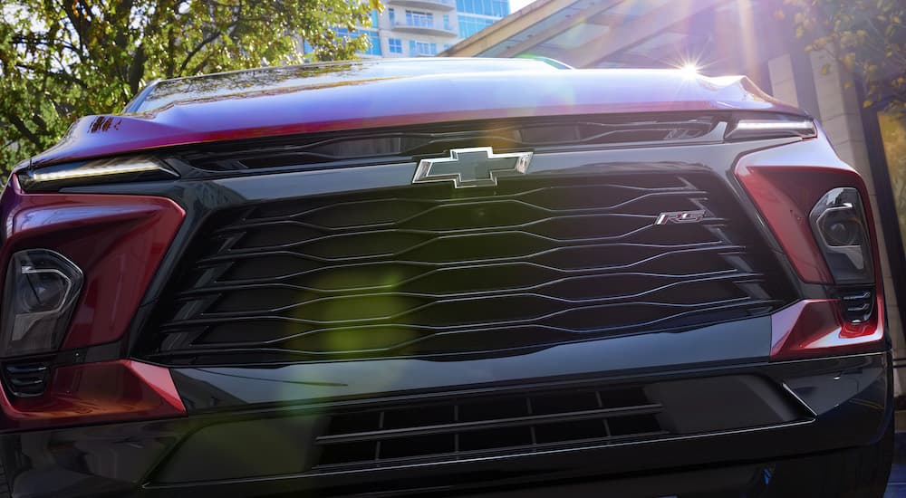 The grille of a red 2023 Chevy Blazer RS is shown from a low angle.