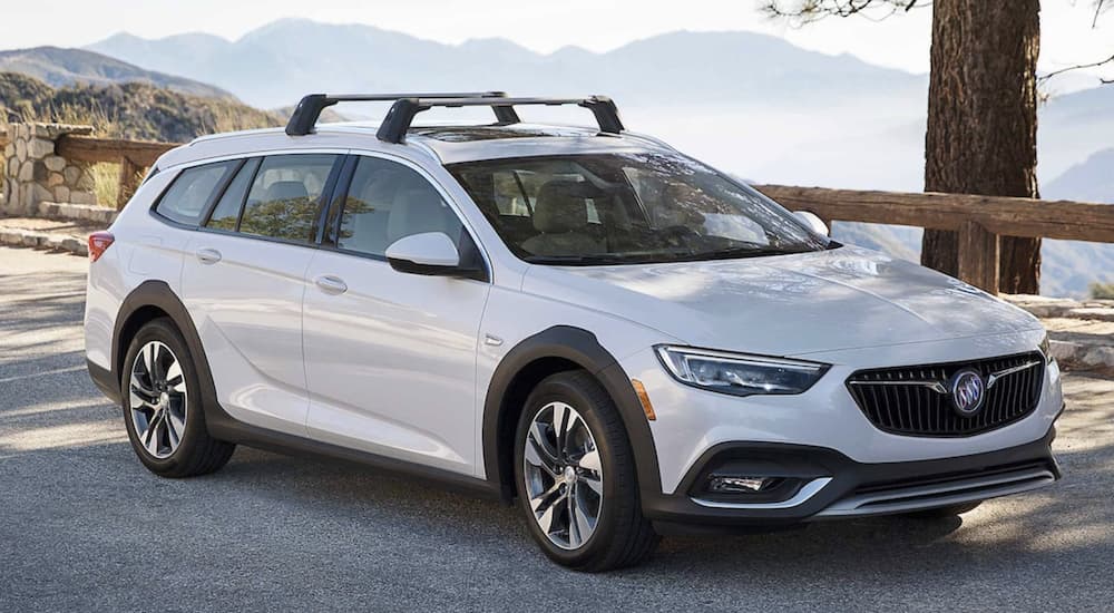 A white 2022 Buick Regal is shown from the side parked in front of a mountain look out.