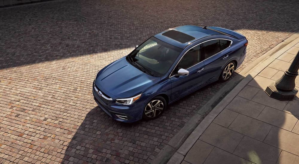 A blue 2021 Subaru Legacy is shown from above parked in a city.