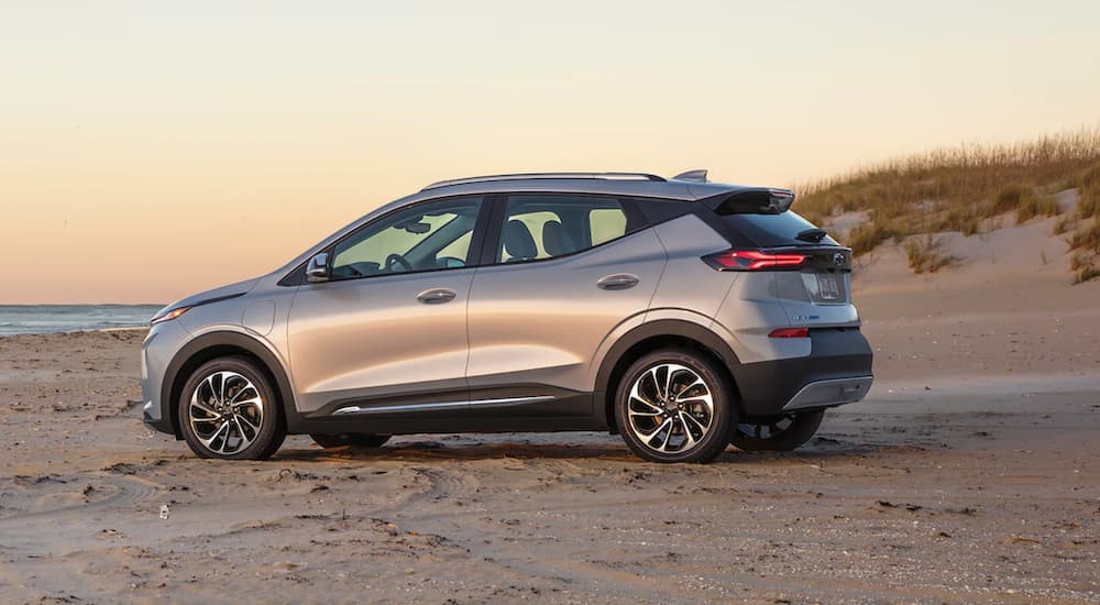 A silver 2022 Chevy Bolt EUV is shown from the side parked on a beach.