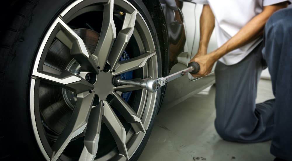 A mechanic is shown adjusting a tire.