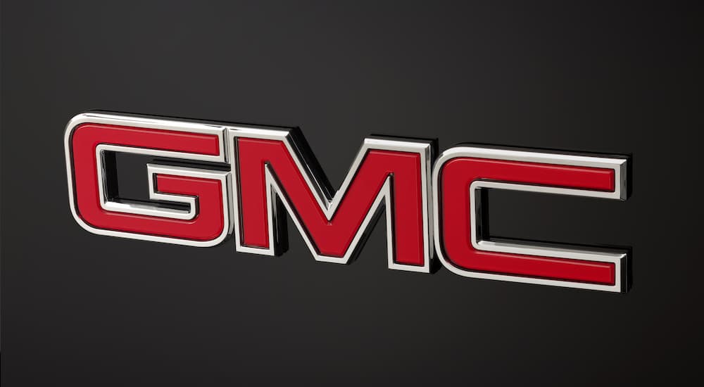 The red GMC logo is shown on a 2014 GMC Yukon XL Denali at a GMC dealer near you.