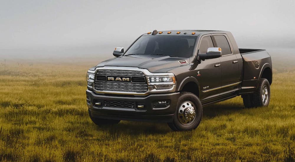 A grey 2022 Ram 3500 is shown from the front at an angle while parked in the field after leaving a used diesel truck dealership.