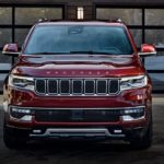 A red 2022 Wagoneer is shown from the front parked in front of a house after leaving a Wagoneer dealer.