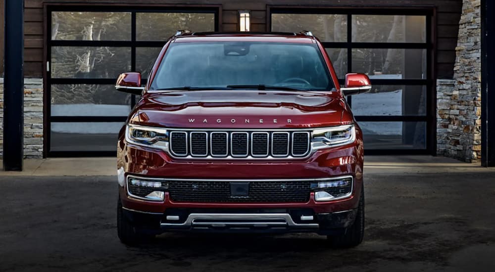 A red 2022 Wagoneer is shown from the front parked in front of a house after leaving a Wagoneer dealer.