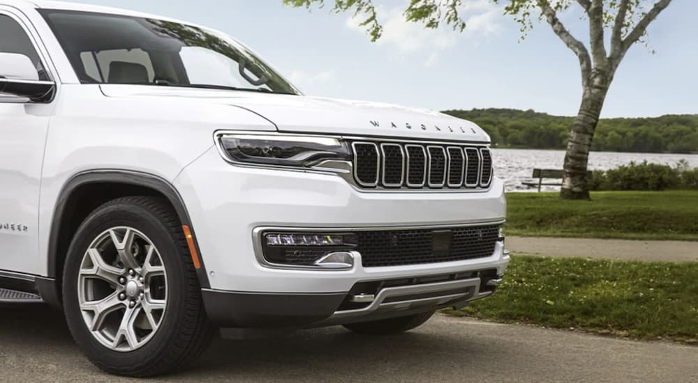 A white 2022 Wagoneer is shown from the front driving on an open road.