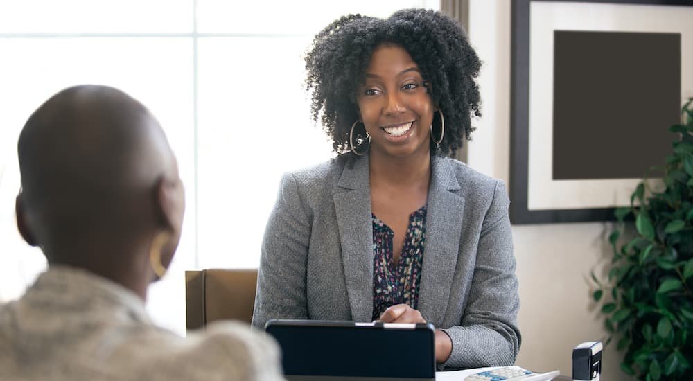 A person is shown explaining bad credit car loans to a customer.