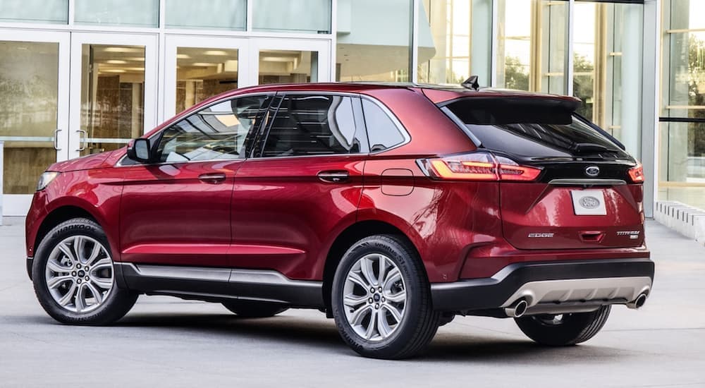 A red 2020 Ford Edge Titanium is shown from the side.