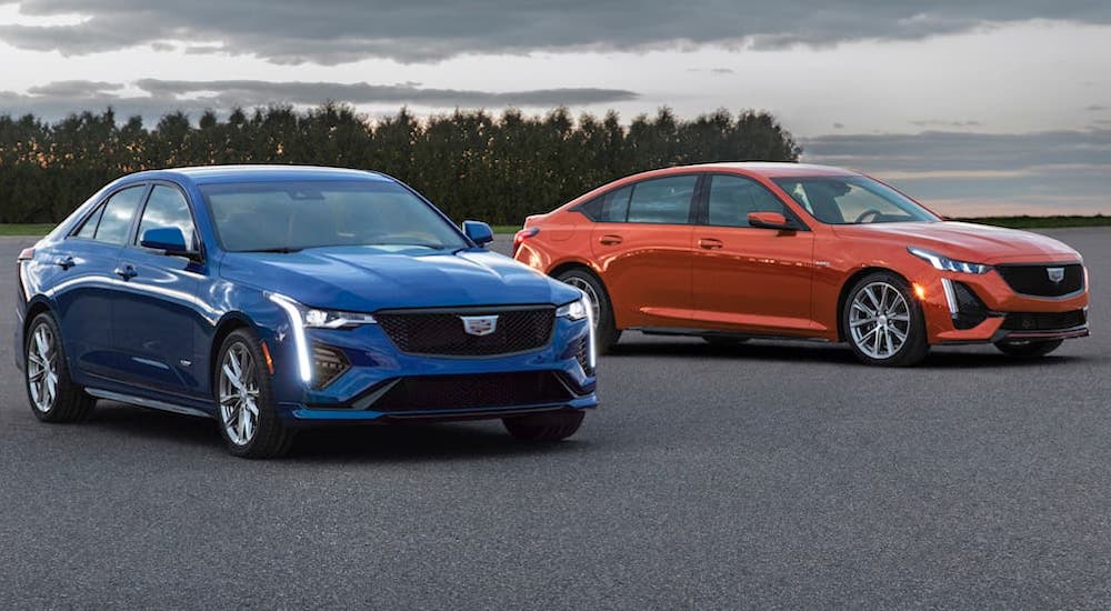 A blue 2020 Cadillac CT-4 V and a red 2020 Cadillac CT-5 V are shown parked in a lot.