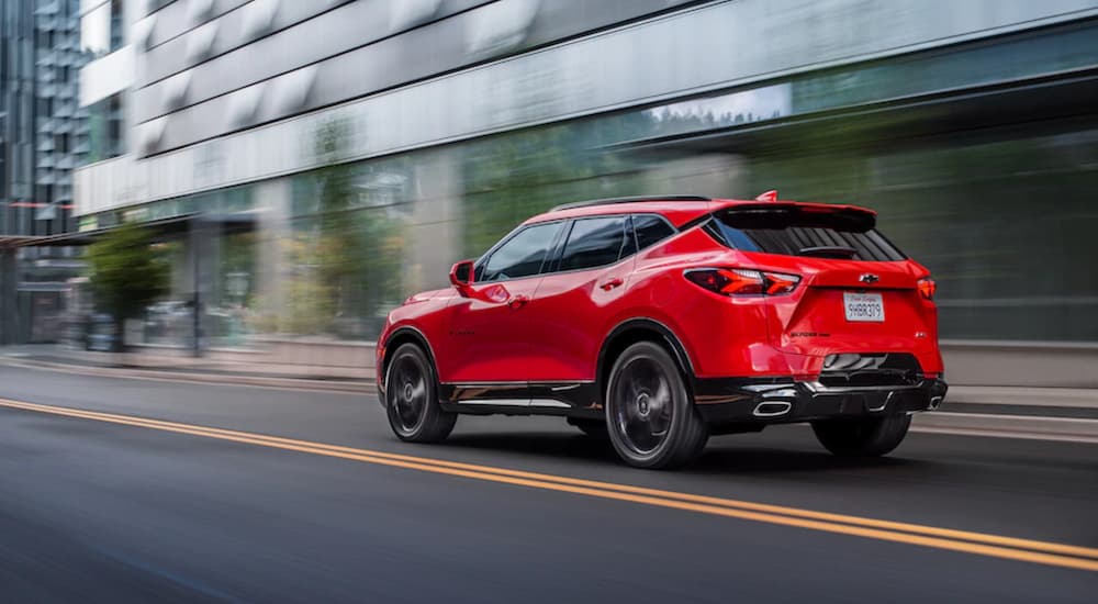 A red 2020 Chevy Blazer is shown from the rear while driving through the city after leaving a dealer that handles Seattle online car sales.