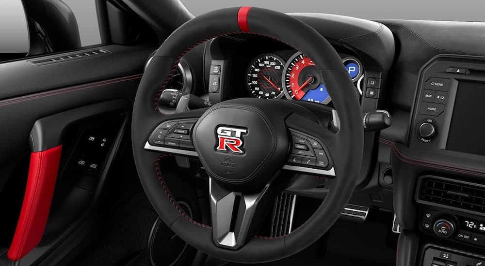 The steering wheel and gauges of a 2021 Nissan GT-R Nismo is shown.