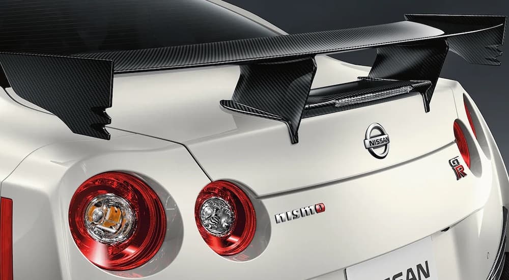 The rear spoiler of a white 2021 GT-R Nismo is shown close up.