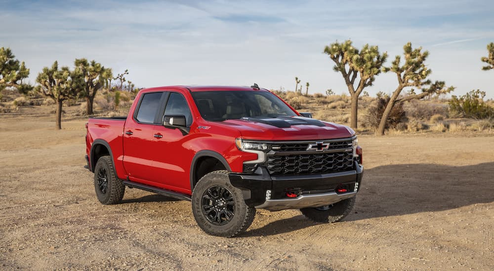 A red 2022 Chevy Silverado ZR2 is shown from the front at an angle while parked in the desert after leaving a Chevy dealer in OH.