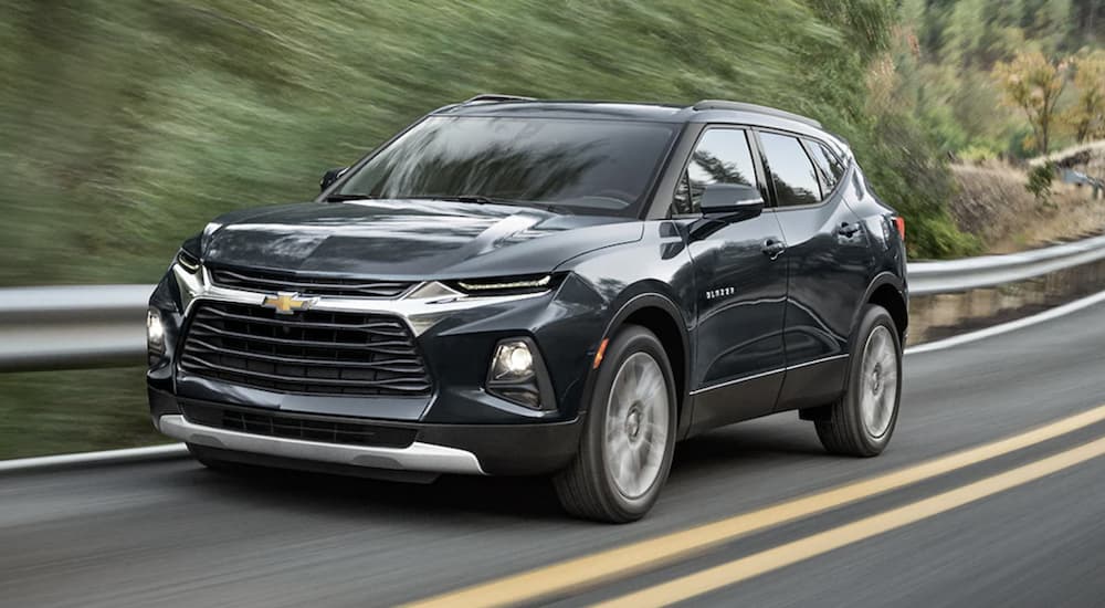 A black 2022 Chevy Blazer Premier is shown from the front driving on an open road.